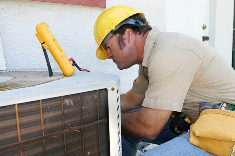 Van Biljoens technician servicing an air conditioning unit for a Pretoria home